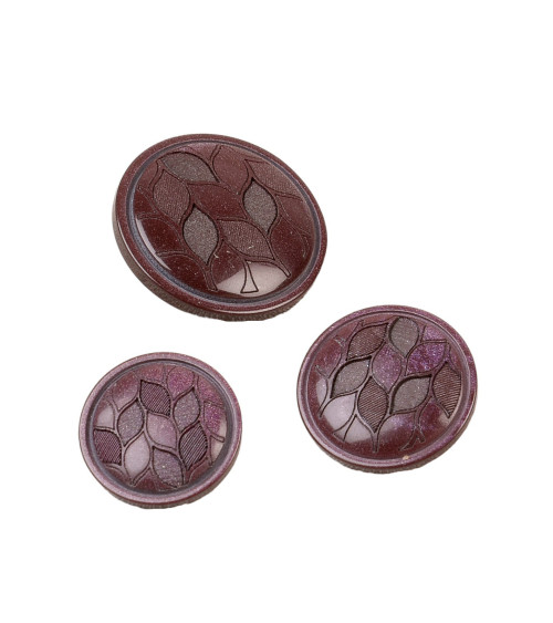 Round button with dark burgundy red leaf tail